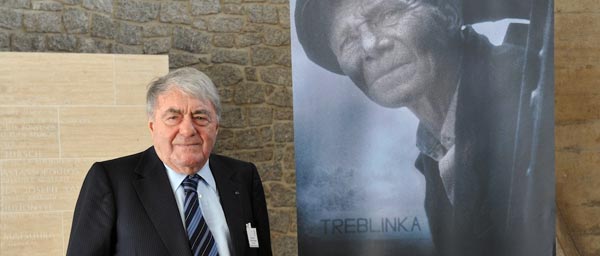 Director Claude Lanzmann with a poster for the film Shoah. A Claims Conference grant allowed the film to be shown and distributed in 10 Muslim countries.